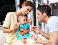 Photo of a woman, a man, and a baby.