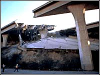 Photo of a freeway broken apart as a result of an earthquake.