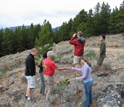 Photo of undergraduate and graduate students scoping out the landscape on a field trip.