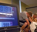 Photo of cyclists powering the SC648 SiCortex supercomputer through their pedal strokes.