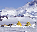 A group of Scott tents pitched in the shadow of the Transantarctic Mountains.