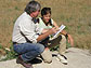 Two researchers hover over field notes.