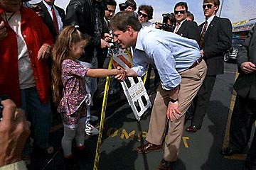 Photo of a little girl shaking Al Gore's hand.