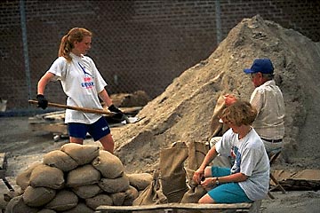 Photo of people filling sand bags.