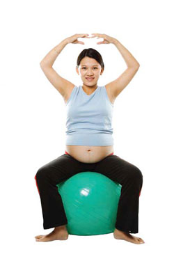 A pregnant woman on an exercise ball