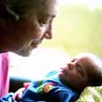 Photo of a grandparent holding an infant grandchild