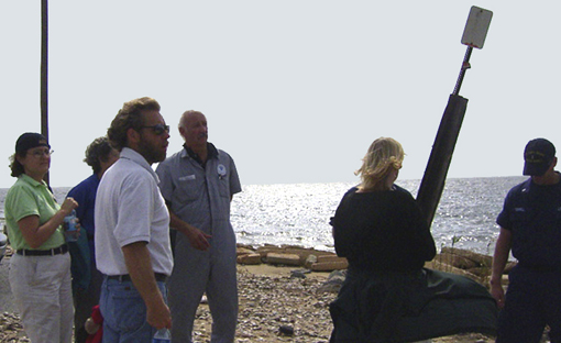 Group of people standing on a beach.