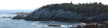 Cliffs on Isle au Haut rise high over the sea.