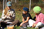 Volunteer talks with two kids