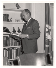 [U.S. Surgeon General Luther Terry standing in front of bookcase]. 1965.