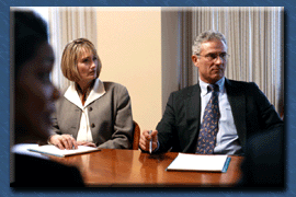 People seated at conference table