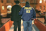 ICE agent escorting man
