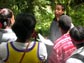 Photo of rapper C.A.U.T.I.O.N. engaging kids from Washington State exploring the forest environment.