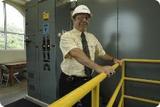 Jim Tomaine stands near elevated controls. Photo by Leif Skoogfors, FEMA.