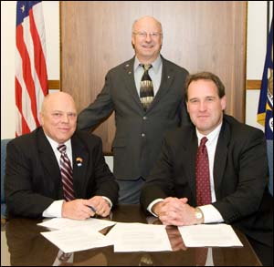 (L to R, sitting) Steven Wiege, National President, IEC; and Thomas Stohler, former-Acting Assistant Secretary, USDOL-OSHA; (Standing) John Masarick, Director of Workforce Development, Codes & Safety, IEC; at the OSHA and IEC national Alliance renewal signing on December 8, 2008.