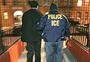 ICE agent escorting man