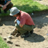 Image of a woman bending over a garden with a trowel, signifying how individuals can be a part of the environment