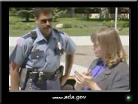 photo of a policeman talking to a woman who uses sign language