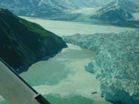 June 13, 2002, west-view from above Russell Fiord, looking toward Yakutat Bay and Turner Glacier. The advancing terminus of Hubbard Glacier is in the foreground. The point of closure is not visible, blocked from view by Gilbert Point. USGS Photograph by Bruce F. Molnia (6/13/02-24).