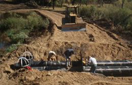 Construction crew installing levelers to innudate area and create wetlands