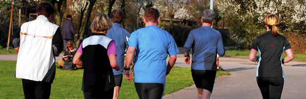 Adults running along a path