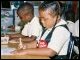 Two students work on assignments during Secretary Paige's visit.