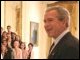 President Bush greets the 2005 Presidential Scholars during a group photo shoot in the East Room. Chosen from more than 2,700 high school candidates, 141 scholars are honored for their accomplishments in academics and the arts.  White House photo by Eric Draper