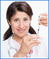 Healthcare worker holding a syringe.