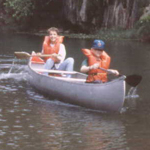 kids in a canoe, wearing life jackets