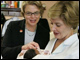 Laura Bush and Secretary Spellings meet newborn Iriella Johnson and her mother Irene Johnson, one of the many families displaced from New Orleans by Hurricane Katrina, during a visit to the Goodman Oaks Church of Christ in Southaven, Mississippi.  <i>White House photo by Krisanne Johnson</i>