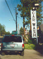 image of car near car wash sign