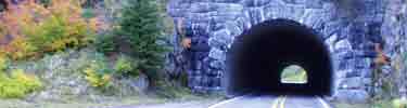 Fall colors decorate the hillside surrounding the historic road tunnel on SR 123