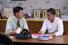 Male tutor and male student sitting at a table.