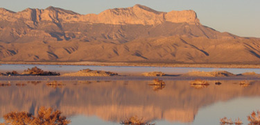 The ephemeral salt lake reflects a mirror image of Guadalupe Mountains.