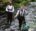 Photo of three researchers in a river.