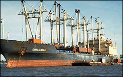 Damaged vessel at anchor after storm.