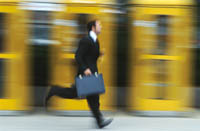 Man with briefcase running fast.