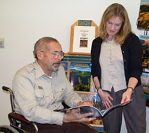 Volunteer assista a visitor with directions in the Headquarters Visitor Center.