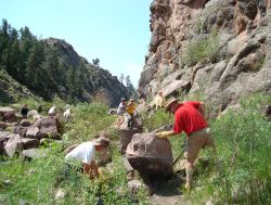 Volunteers cleaning up trails and removing large boulders