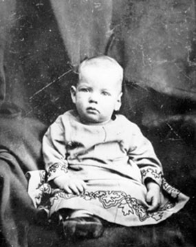 Black-and-white studio photograph of a seated baby.