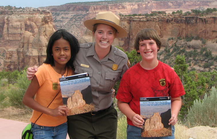 Two New Junior Rangers with a Park Guide.