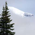 Mount Rainier partially obscured by clouds.