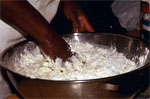 Hand in a large bowl of batter