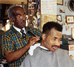 McDowell cutting a customer's hair in the barber shop