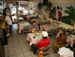 Inside of a restaurant, with customers eating at tables