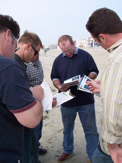 Emergency responders gather on a beach for shoreline cleanup training.