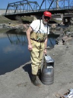 USGS scientist with a sediment sampler on the banks of the South Platte River, CO, during a sampling trip for the National Streambed-Sediment Reconnaissance for Emerging Contaminants Project