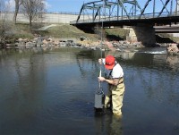 USGS scientist sampling sediments from the South Platte River, CO, for the National Streambed-Sediment Reconnaissance for Emerging Contaminants Project