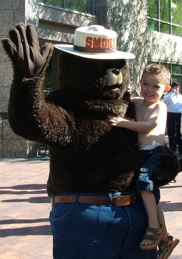 Smokey Bear greets a child