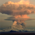 Mushroom-shaped ash cloud rising thousands of feet above Redoubt Volcano during its eruption on April 21, 1990.